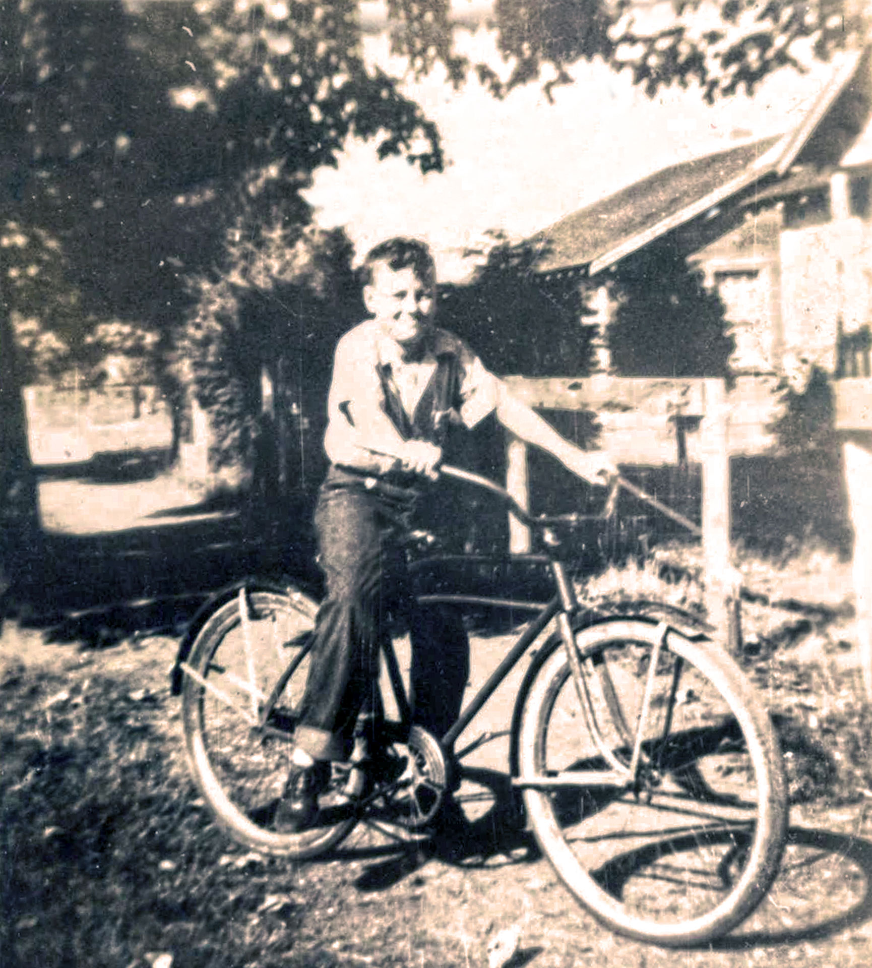 David Burch on his bike, delivering newspapers in Ryderwood.