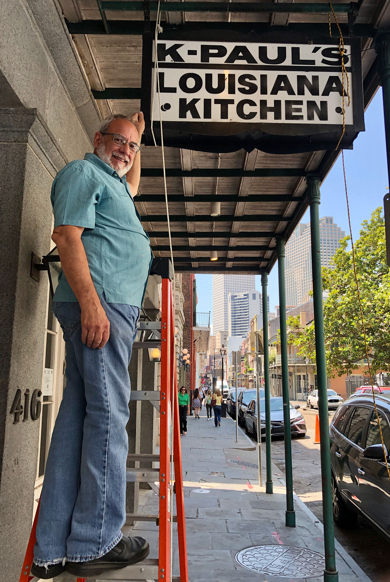 K-Paul's final chef, Paul Miller, taking down the restaurant's sign on May 11 of this year (all photos by James Cullen)