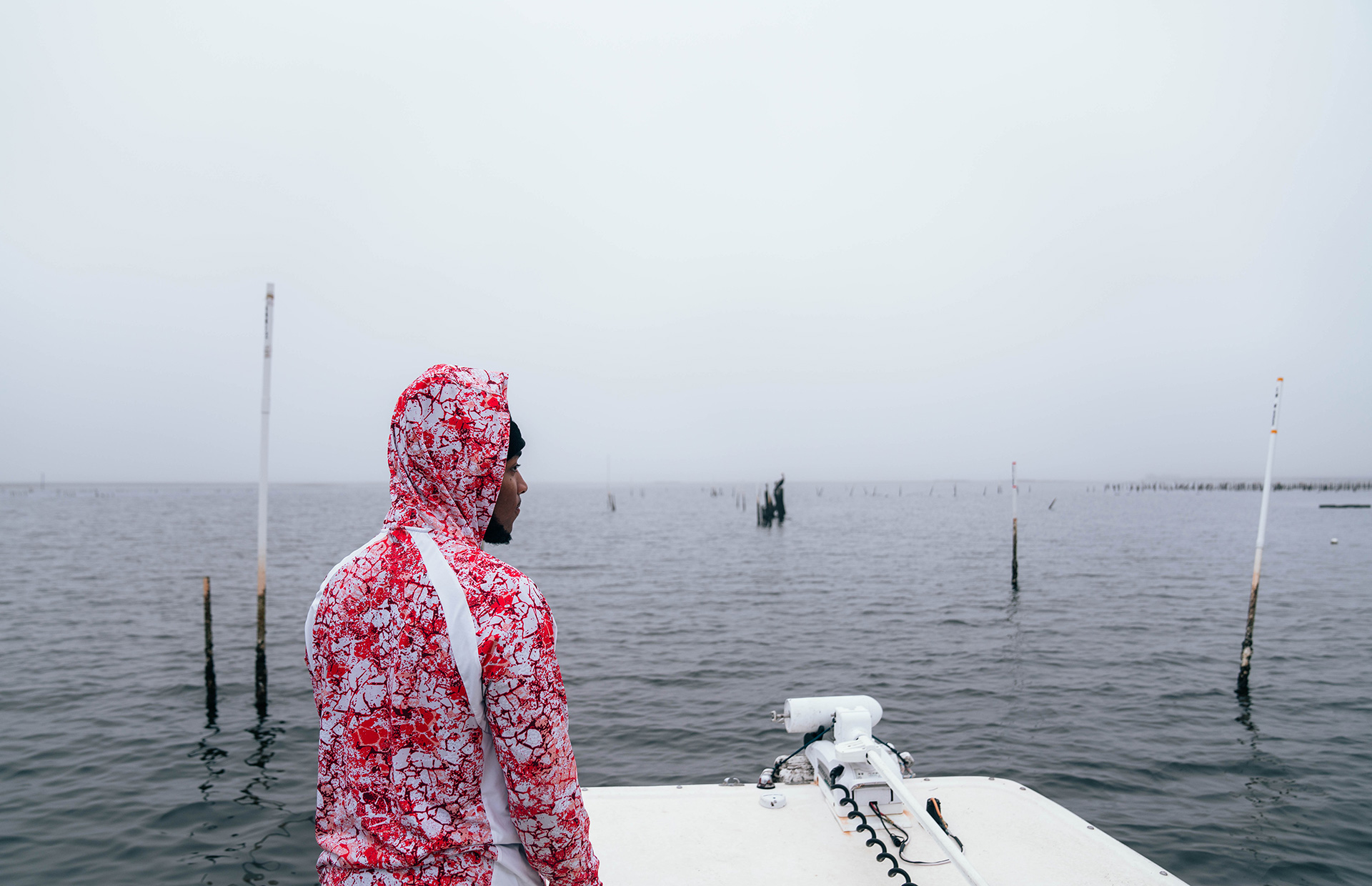 Adrian Morris surveys the oyster leases as the boat pulls up in the morning fog. After working with Jody’s crew, he is now working toward getting his own Spring Creek lease up and running.