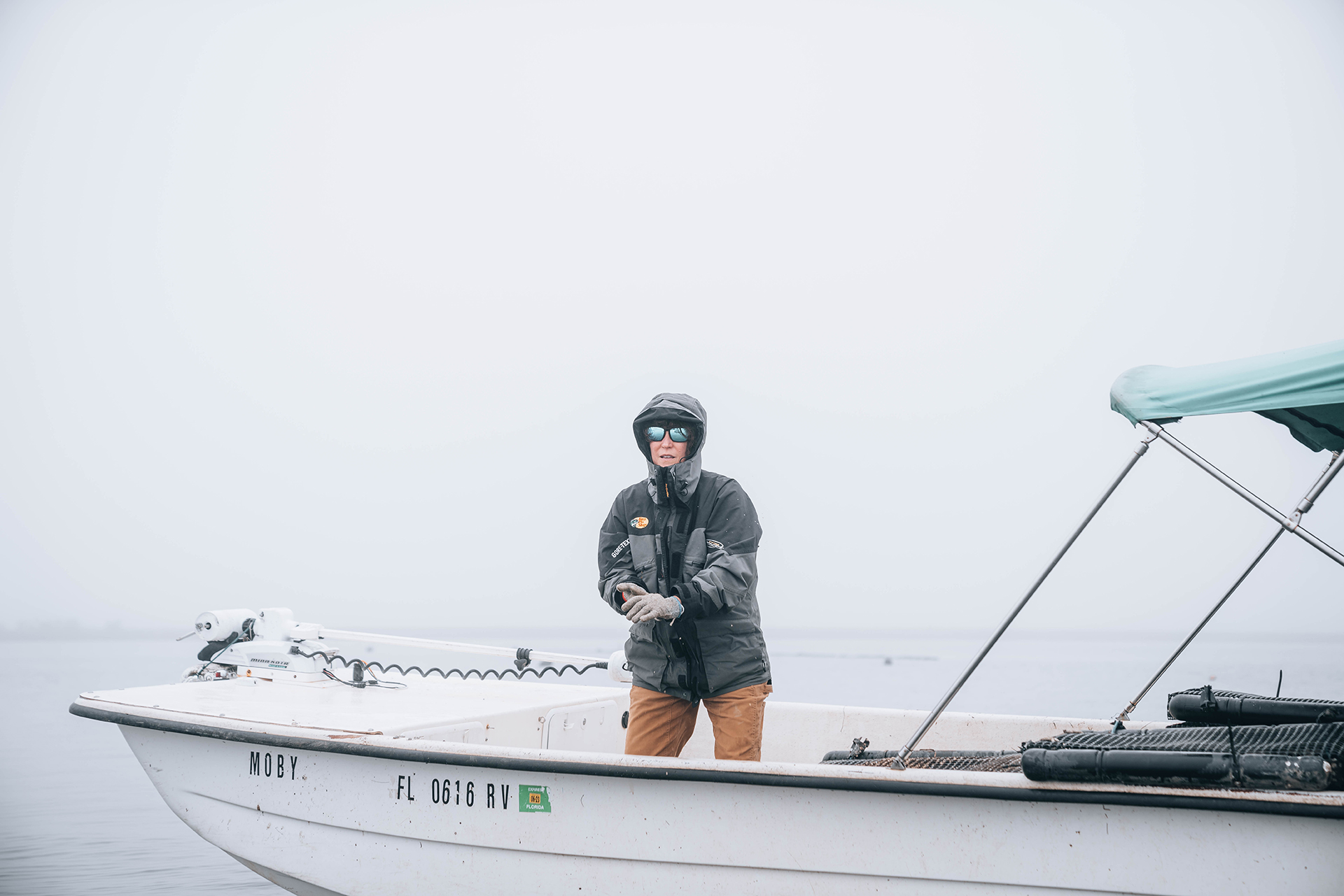 Most mornings, Jody and the crew start their day as the sun is about to come up. On this particular morning, a thick fog hangs low over the water. and the temperature is especially cold for North Florida. The first order of business is heading out to check the oysters and pull any from the water that have grown and are ready to be resorted or sent to market.