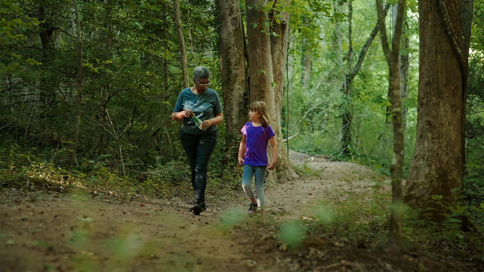 Stephanie Swepson Twitty walks along a section of trail with Eva Jennings, daughter of U.S. Forest Service employee Lisa Jennings. (Photo courtesy of White Blaze Marketing)