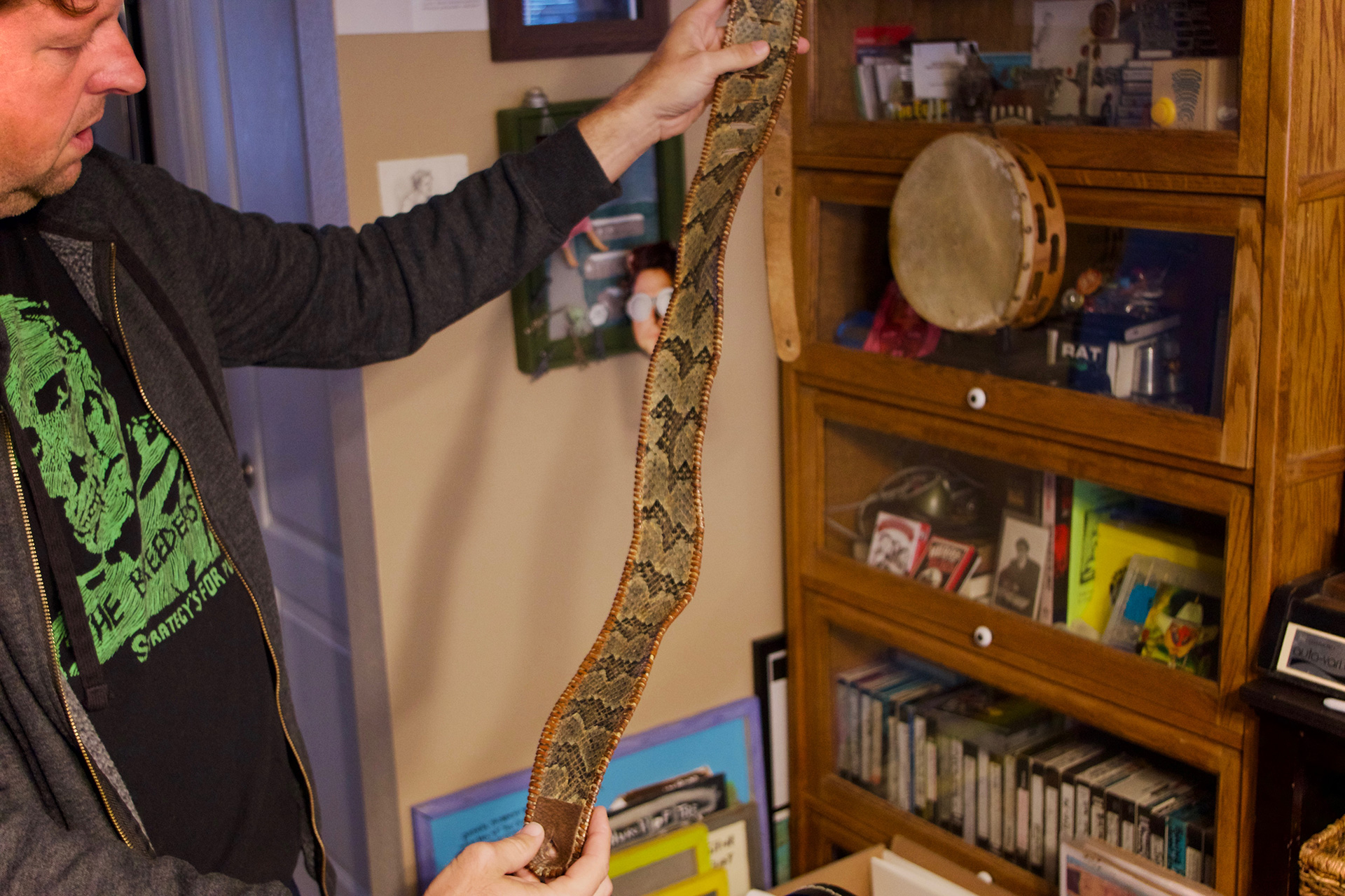 CONDENSED-abe-with-snakeskin Abe with a guitar strap made from the skin of Old Lemonhead, a prized rattlesnake from the Coots family's church (photograph by Eli Bartlett)