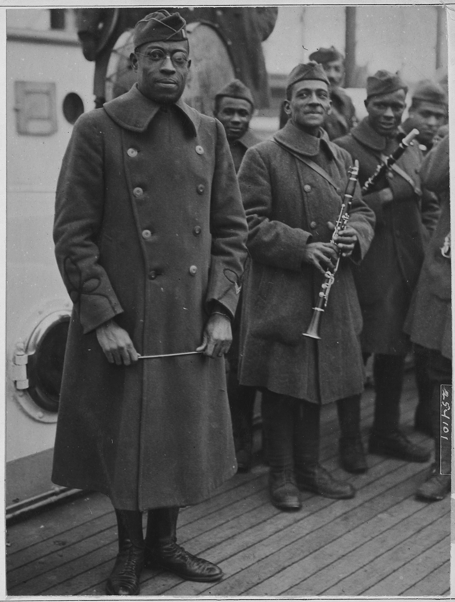 CONDENSED-african-american-jazz-band-leader-back-with-african-american-15th-lieutenant-credit-U.S.-National-Archive-and-Records-Administration-1918- James Reese Europe and his 369th Regiment bandmates in 1918, ready to ship out for Europe. (Photo courtesy of the U.S. National Archives and Records Office)