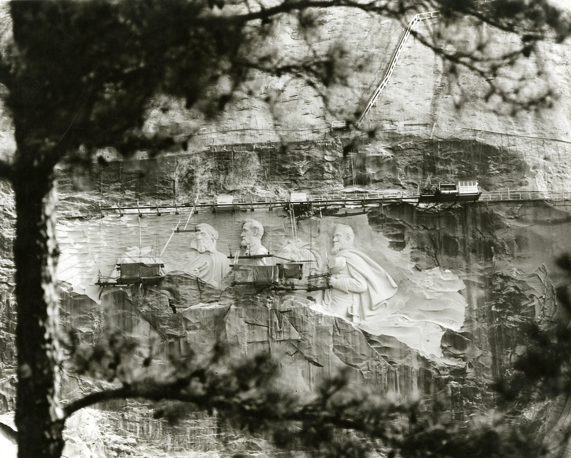 View of the modern-day carving at Stone Mountain in progress. The photograph (courtesy of the Atlanta History Center) bears no specific date, but the carving project began in 1958 and was unveiled in 1970.