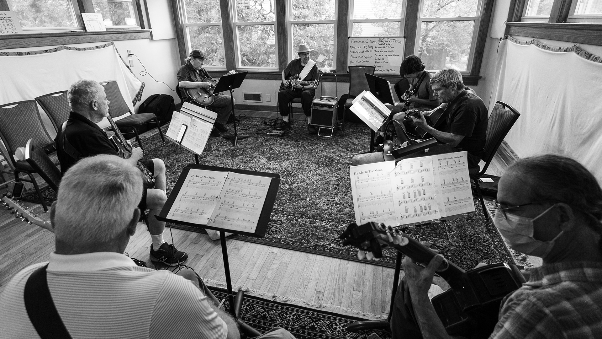 Frank Hamilton leads the Swing Guitar class through "Fly Me to the Moon" at his folk music school in Decatur, Georgia.