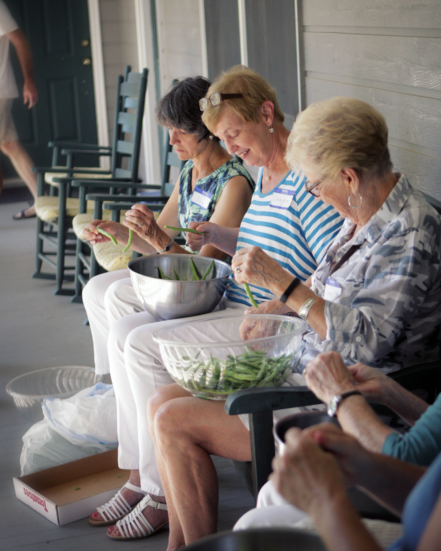 Members of the Jones family string beans on the porch. (Photograph by Kathleen Hunter)