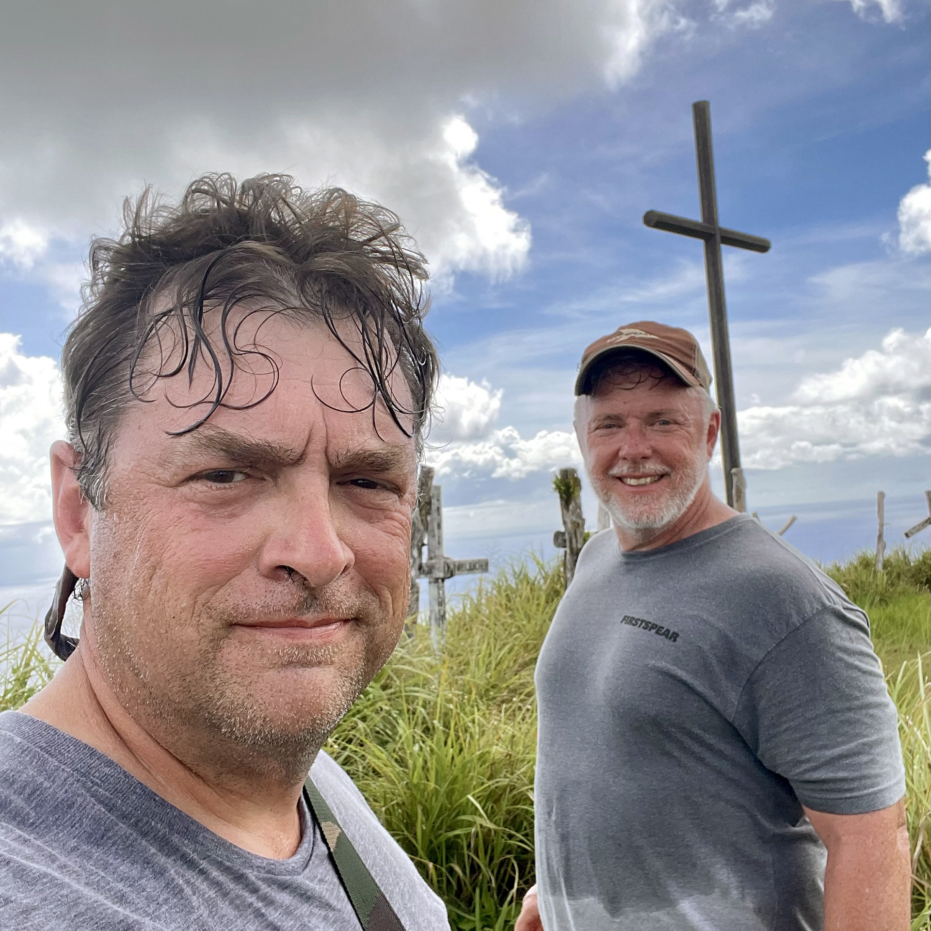 CONDENSED-worth-and-john The author, Russell Worth Parker, with his fellow veteran and diver John Dailey on top of Mount Lamlam in Guam. Lamlam rises from the bottom of the nearby Marianas Trench. If it were entirely above ground, it would be taller than Mount Everest (photograph by Russell Worth Parker).