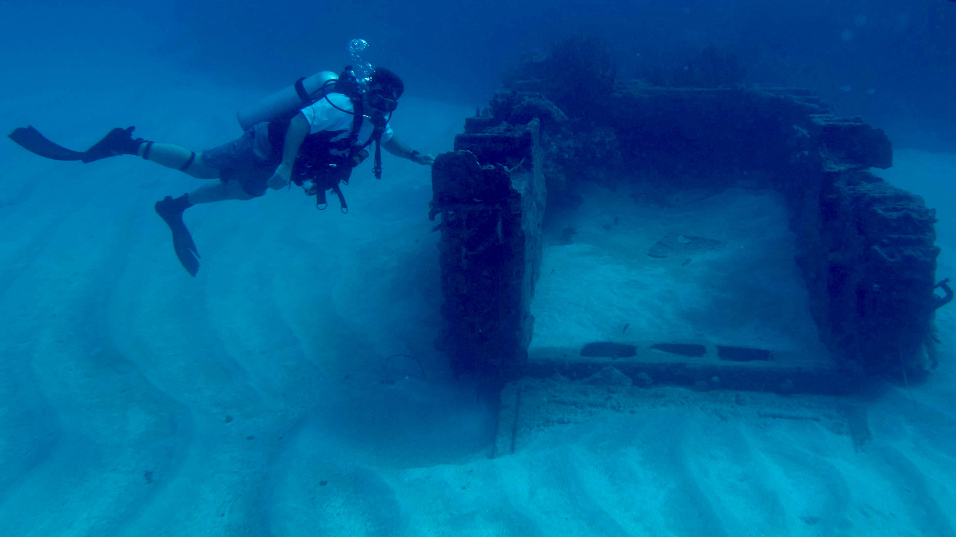 The author undersea with the remains of an amphibious tractor used by American forces during World War II (photograph by Matt Hanks).