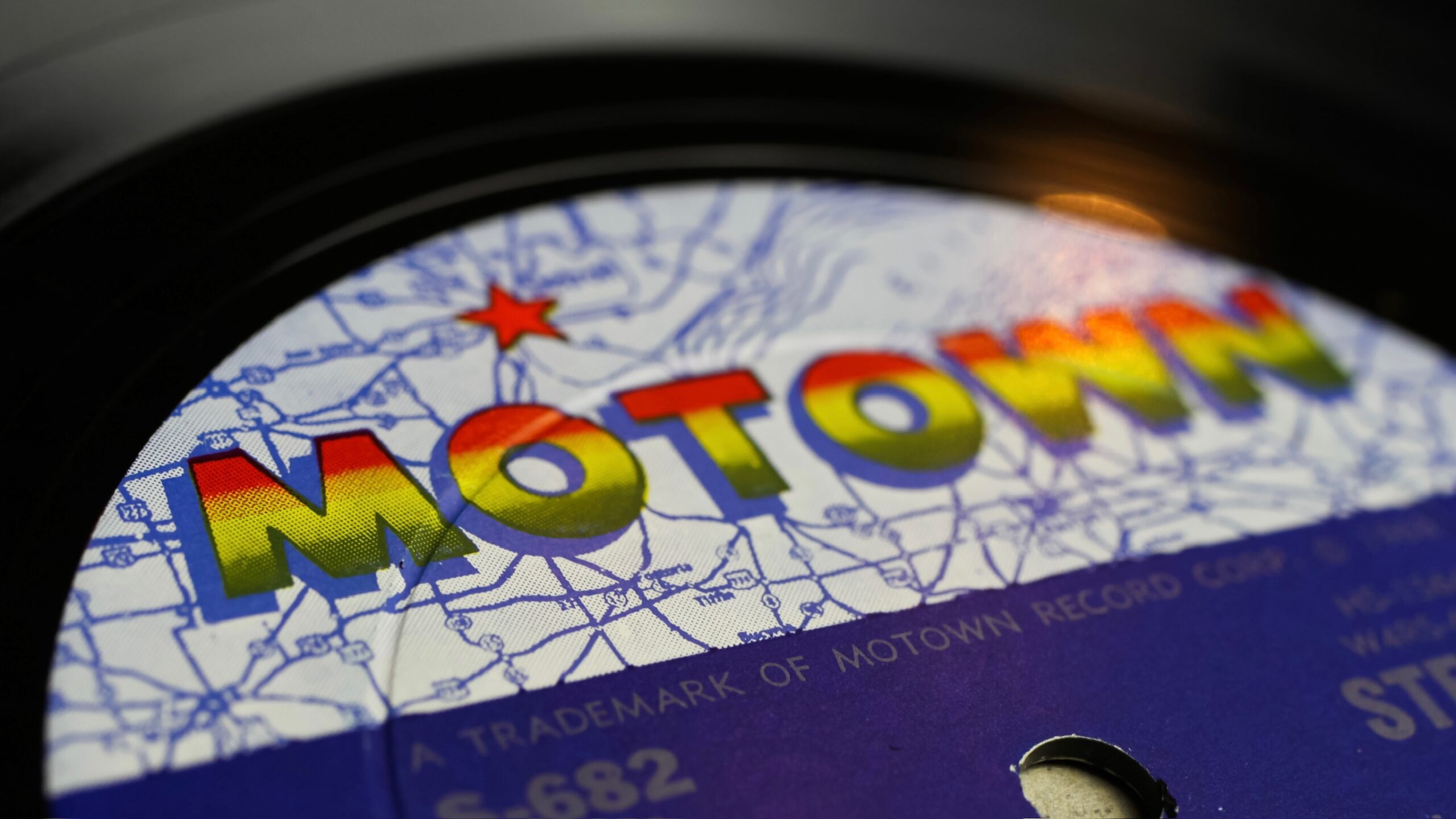 Viersen, Germany - May 9. 2020: Close up of isolated vinyl record album  with logo lettering from Tamla Motwon soul music label (selective focus on letter M left)